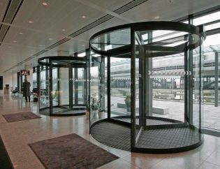 Porta rotativa RevoLine com design elegante numa entrada de edifício
